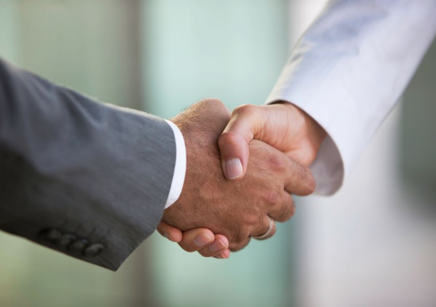 A property manager shakes hands with a Little Elm landlord.